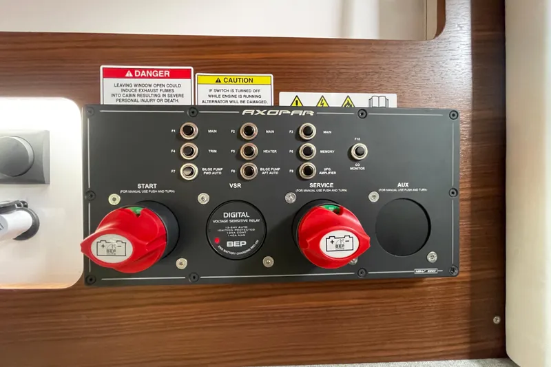 Slide: The Image of Control panel of 2023 Axopar 28 Cabin with warning labels. - 26