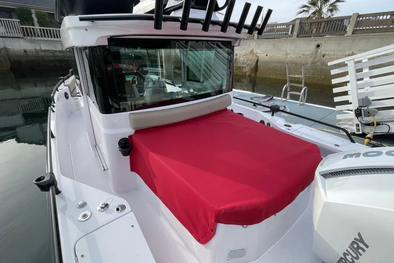 Slide: The Image of 2023 Axopar 28 Aft Cabin with Brabus Trim, featuring red cover and sleek design. - 28