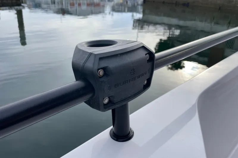 Slide: The Image of Close-up of a 2023 Axopar 28 Aft Cabin with Brabus Trim railing detail. - 31