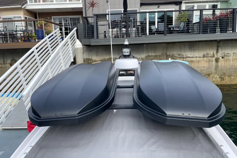 Slide: The Image of 2023 Axopar 28 Aft Cabin with Brabus Trim docked near modern waterfront home. - 34