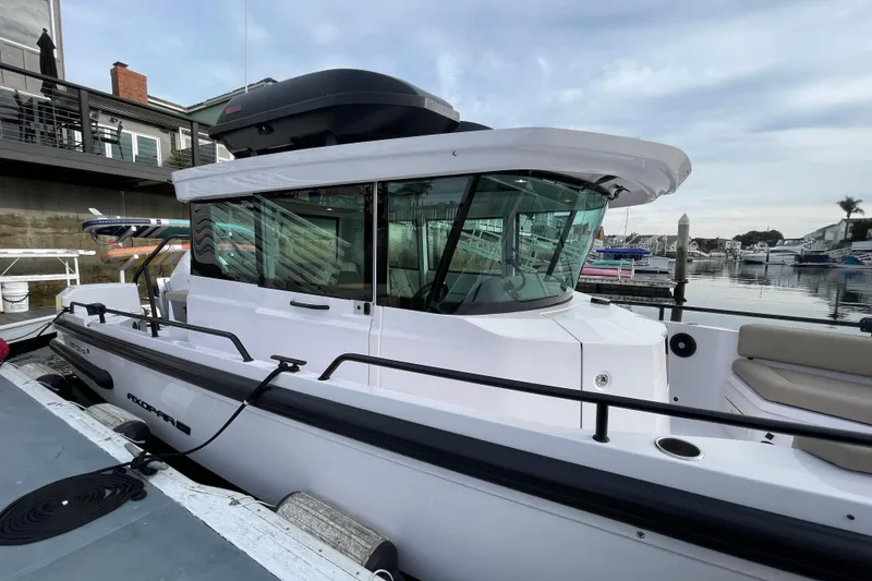 Slide: The Image of 2023 Axopar 28 Aft Cabin with Brabus Trim docked at marina. - 5