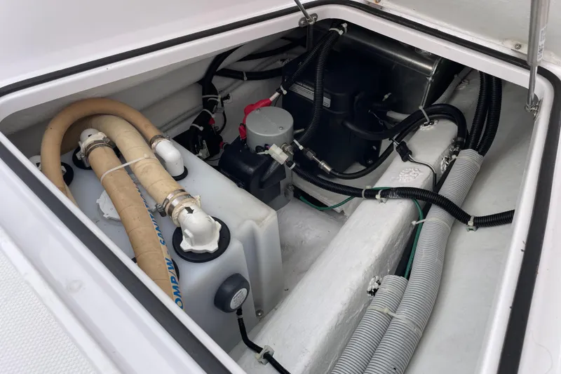 Slide: The Image of Engine compartment of 2023 Axopar 28 Cabin with hoses and cables. - 8