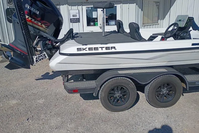 Slide: The Image of 2021 Skeeter ZXR20 boat on trailer with Yamaha engine, parked outside a building. - 6
