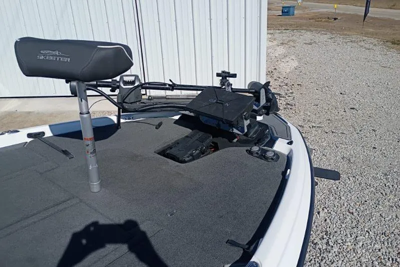 Slide: The Image of 2021 Skeeter ZXR20 boat deck with seat and equipment, parked on gravel. - 7