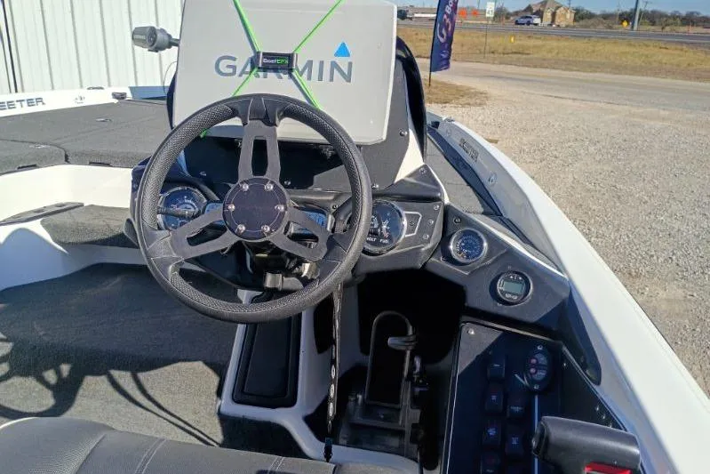 Slide: The Image of 2021 Skeeter ZXR20 boat dashboard with Garmin navigation system and steering wheel. - 8