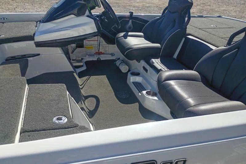 Slide: The Image of 2021 Skeeter ZXR20 boat interior with black seats and modern dashboard. - 9
