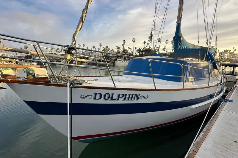 The Image of 1970 CAL 46 Cruiser sailboat named "Dolphin" docked in a marina. - 0