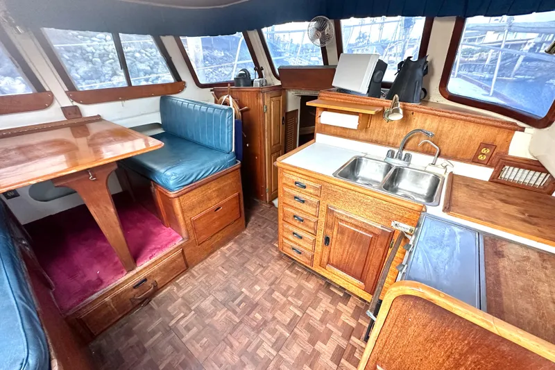 Slide: The Image of Interior of 1970 CAL 46 Cruiser with wooden cabinetry and seating area. - 10