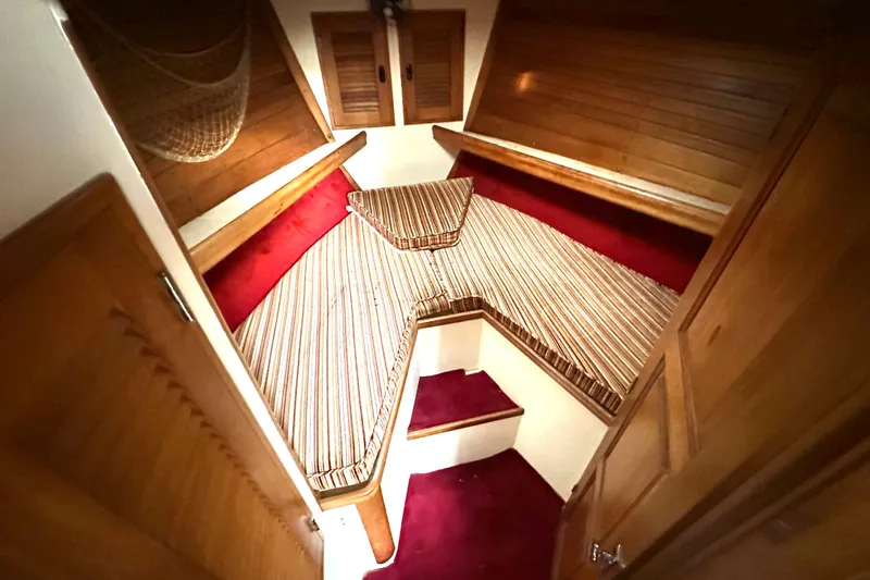 Slide: The Image of Cozy cabin interior of 1970 CAL 46 Cruiser with striped cushions and wooden accents. - 12