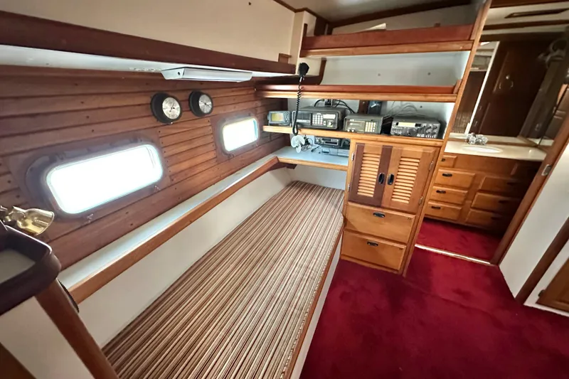 Slide: The Image of Interior of a 1970 CAL 46 Cruiser with wood paneling and navigation equipment. - 15