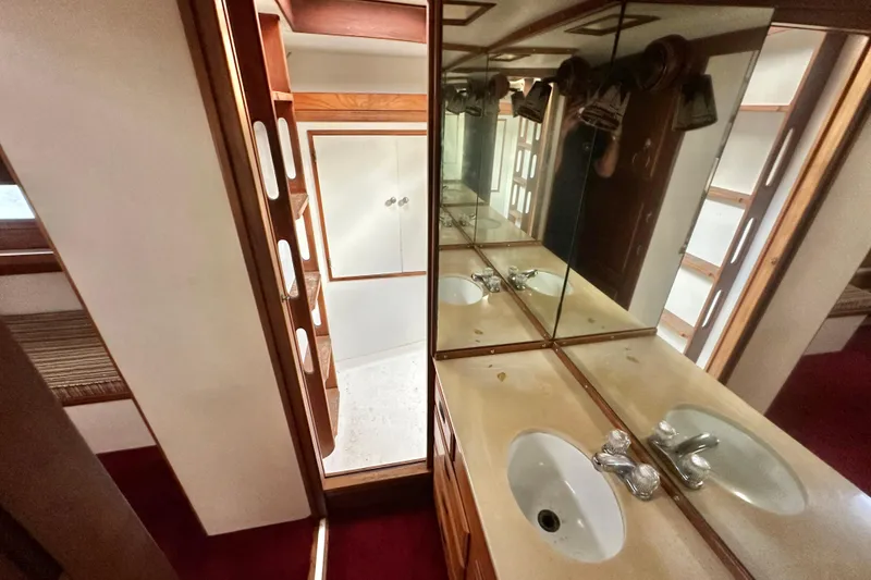 Slide: The Image of 1970 CAL 46 Cruiser bathroom with mirrored cabinets and sink. - 20