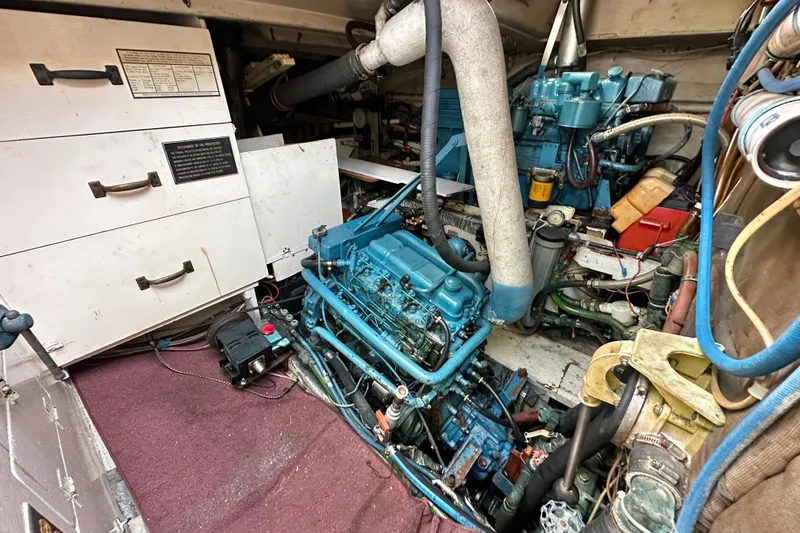 Slide: The Image of Engine room of a 1970 CAL 46 Cruiser with visible machinery and storage compartments. - 23