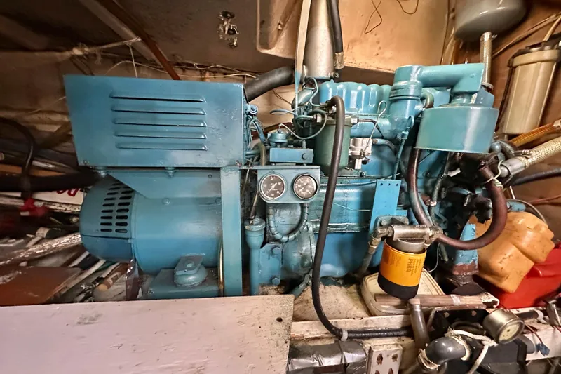 Slide: The Image of Engine room of a 1970 CAL 46 Cruiser with blue machinery and gauges. - 24