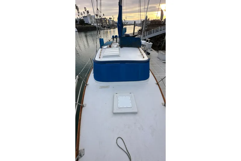Slide: The Image of 1970 CAL 46 Cruiser sailboat deck view at sunset in marina. - 29