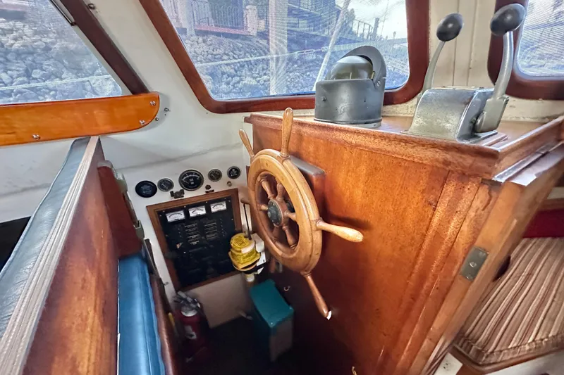 Slide: The Image of Interior helm of 1970 CAL 46 Cruiser with wooden wheel and control panel. - 4