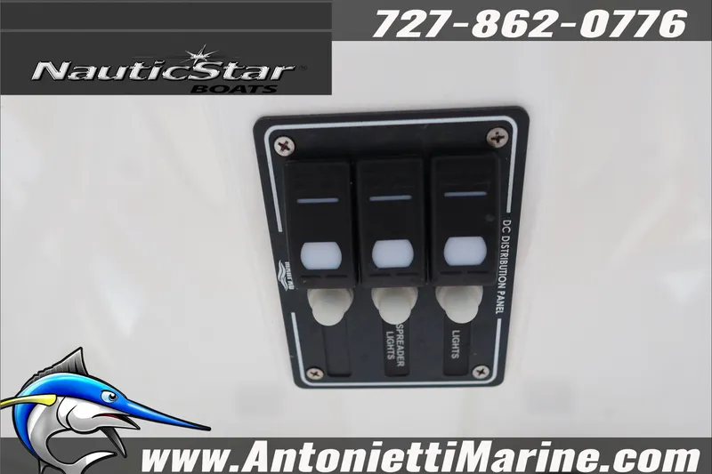 Slide: The Image of Control panel of 2026 NauticStar 222 Offshore boat with switches and branding. - 24