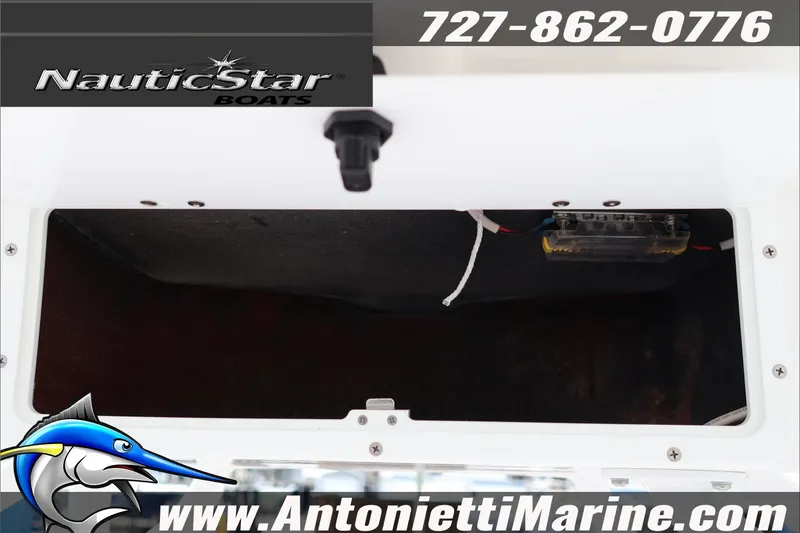 Slide: The Image of 2026 NauticStar 222 Offshore boat compartment with wiring, contact info, and logo. - 26