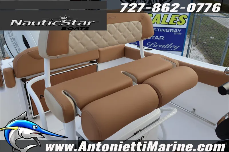 Slide: The Image of 2026 NauticStar 222 Offshore boat interior with tan seating, featuring logo and contact details. - 28