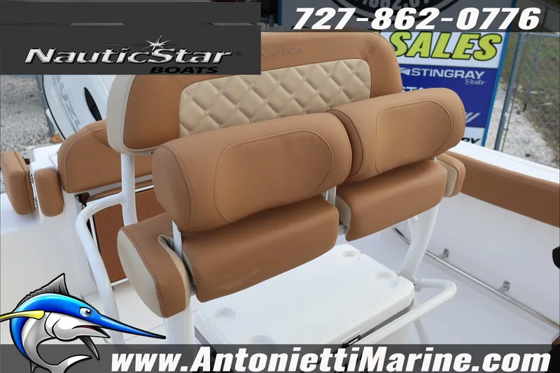 Slide: The Image of NauticStar 222 Offshore 2026 boat seating with tan upholstery and logo branding. - 29