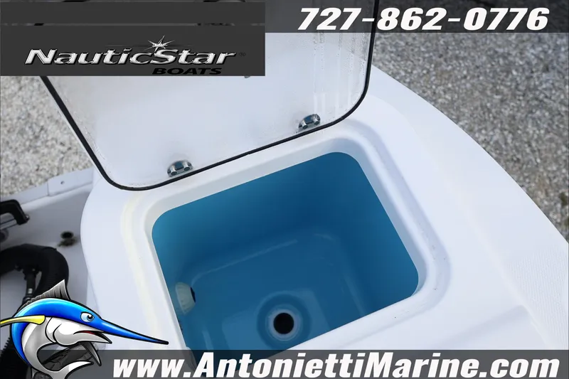Slide: The Image of 2026 NauticStar 222 Offshore boat livewell, featuring open lid and blue interior. - 35