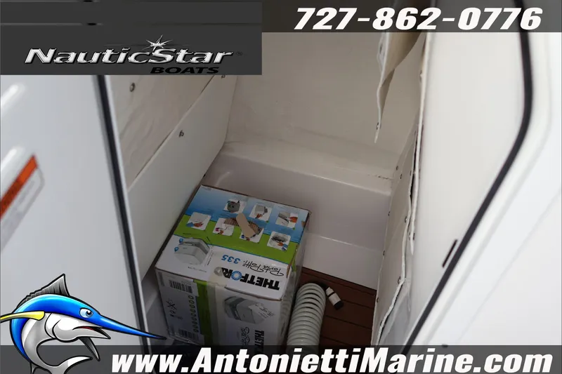 Slide: The Image of Interior storage of 2026 NauticStar 222 Offshore boat with equipment box and hose. - 37
