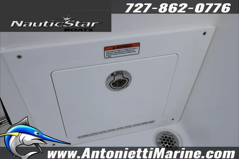 Slide: The Image of 2026 NauticStar 222 Offshore boat compartment with warning label and contact information. - 49