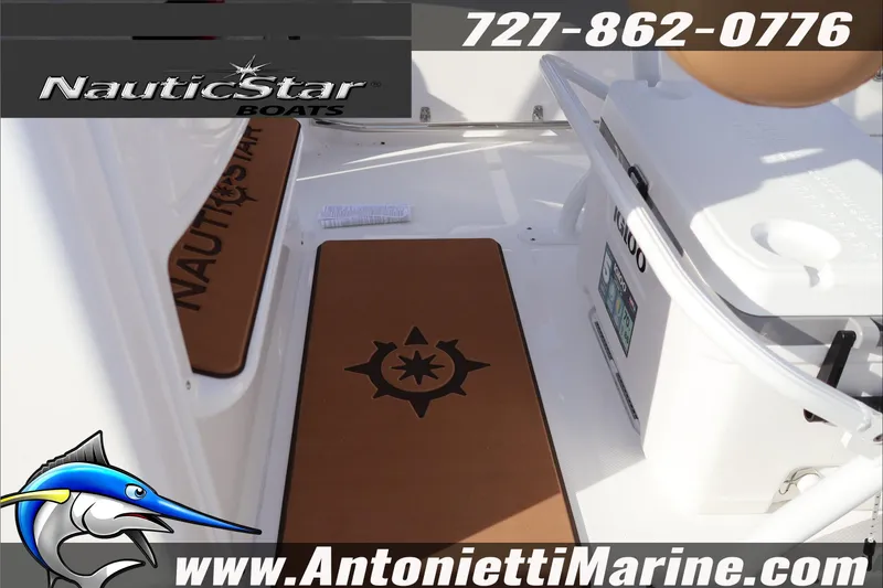 Slide: The Image of 2026 NauticStar 222 Offshore boat interior with branded mats and cooler. - 7