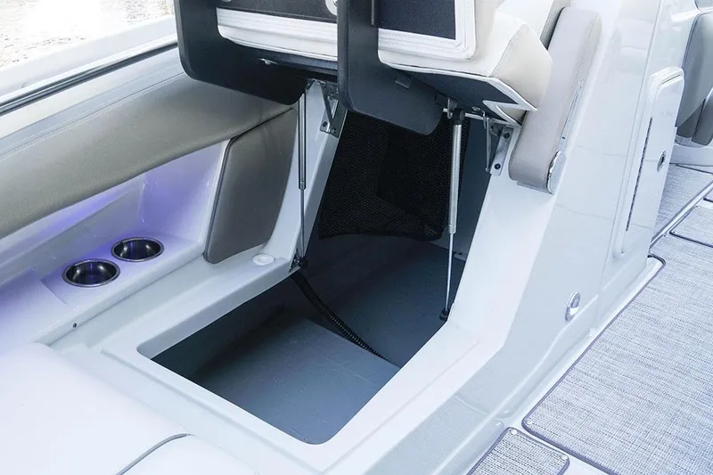 Slide: The Image of 2026 Crownline 288 SS boat interior with storage compartment and cup holders. - 14
