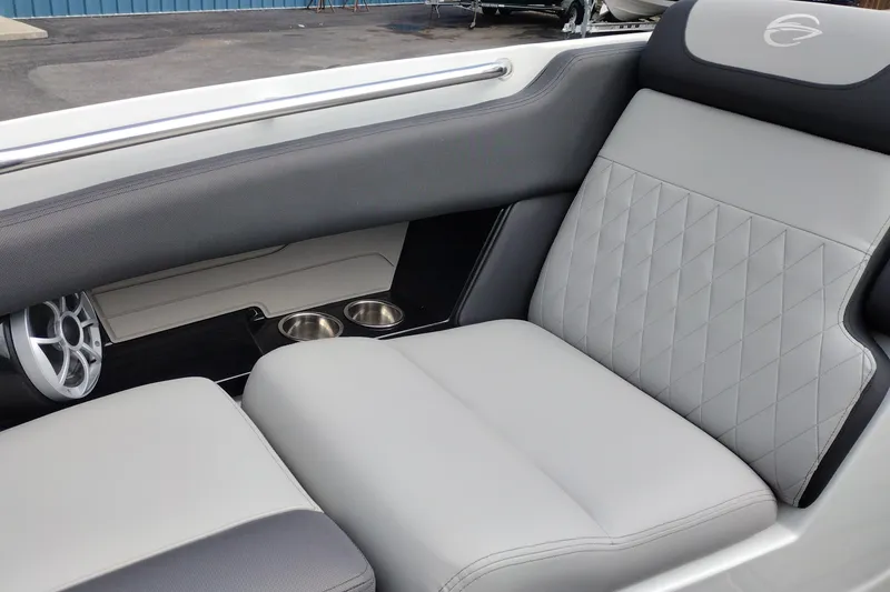 Slide: The Image of 2026 Crownline 288 SS boat interior with gray quilted seating and cup holders. - 17