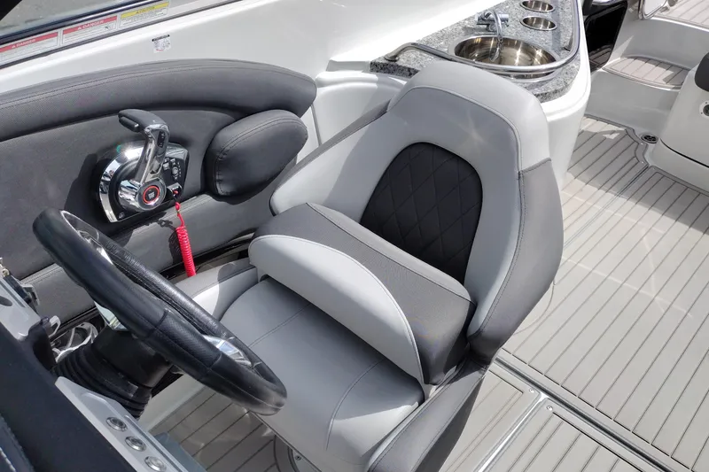 Slide: The Image of 2026 Crownline 288 SS boat interior with steering wheel and luxurious seating. - 23