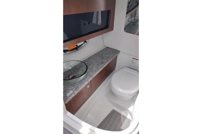 Slide: The Image of 2026 Crownline 288 SS boat bathroom with granite countertop and modern fixtures. - 24