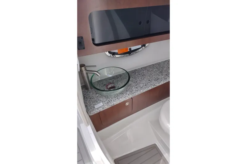 Slide: The Image of Luxurious bathroom interior of 2026 Crownline 288 SS boat with modern glass sink. - 25