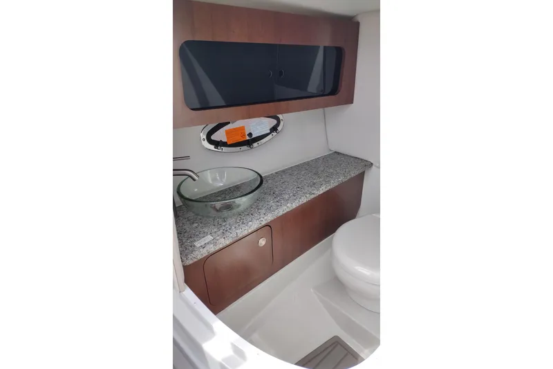 Slide: The Image of 2026 Crownline 288 SS boat bathroom with modern sink and granite countertop. - 26