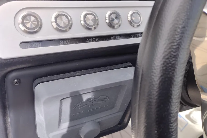 Slide: The Image of Control panel of 2026 Crownline 288 SS boat with labeled buttons and steering wheel. - 31