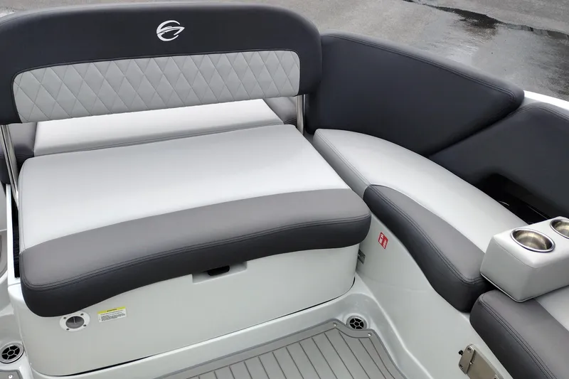 Slide: The Image of 2026 Crownline 288 SS boat interior with gray and white seating, cup holders, and diamond stitching. - 42