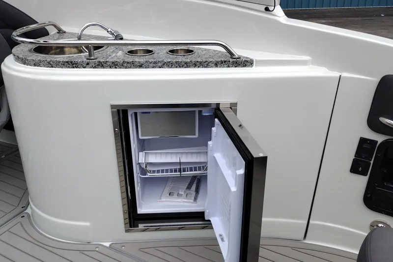Slide: The Image of Open mini fridge and sink on 2026 Crownline 288 SS boat deck. - 44
