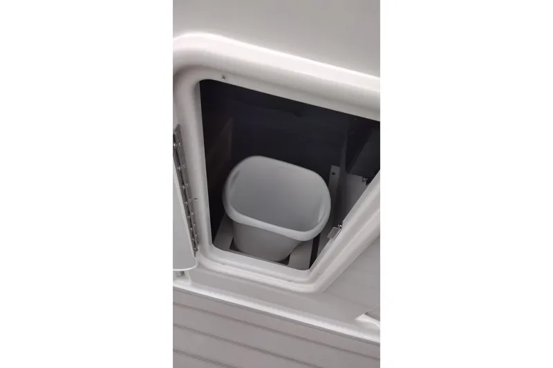 Slide: The Image of Storage compartment with trash bin on 2026 Crownline 288 SS boat. - 47