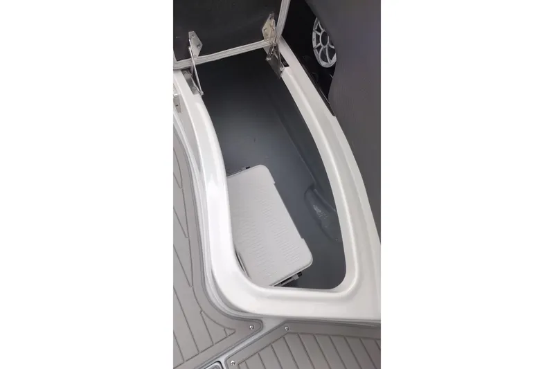 Slide: The Image of Storage compartment in 2026 Crownline 288 SS boat, featuring sleek design and integrated speaker. - 51