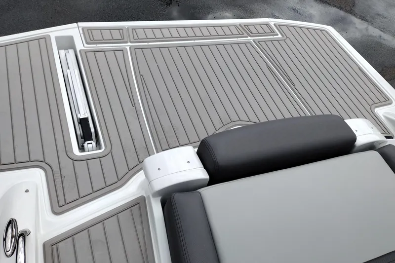 Slide: The Image of 2026 Crownline 288 SS boat deck with gray cushioned seating and integrated storage. - 54