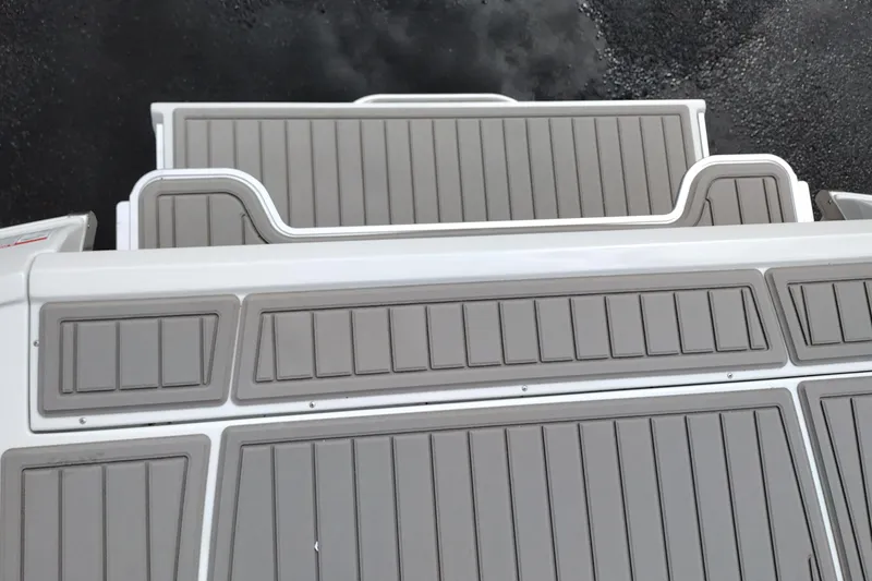 Slide: The Image of 2026 Crownline 288 SS boat deck with sleek, modern design and gray paneling. - 57