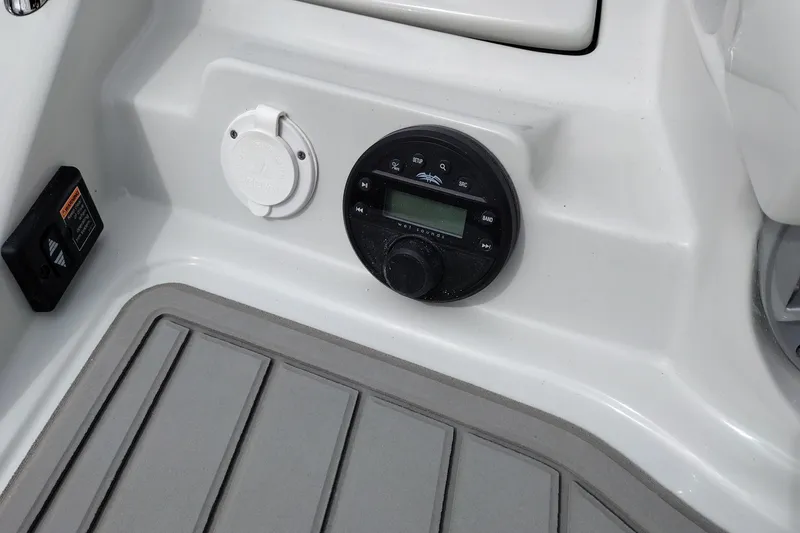 Slide: The Image of Control panel on 2026 Crownline 288 SS boat, featuring audio system and deck flooring. - 58