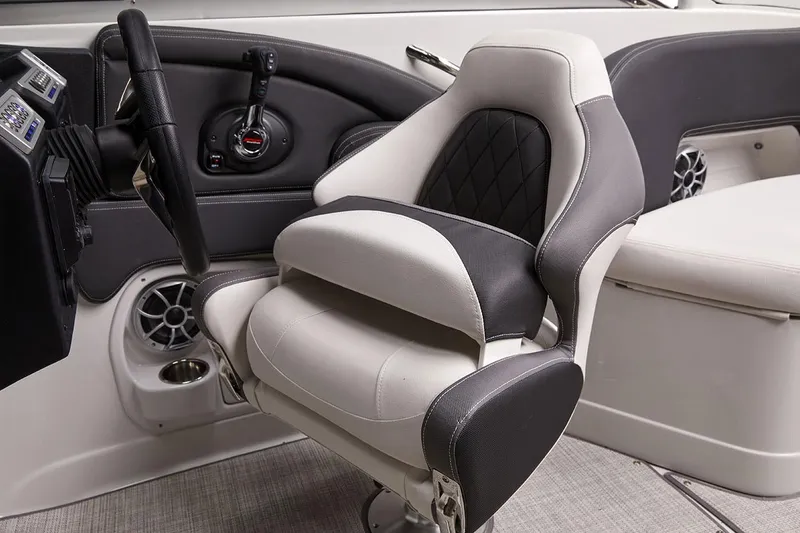 Slide: The Image of Captain's seat and helm of 2026 Crownline 288 SS boat, featuring modern controls and speakers. - 7