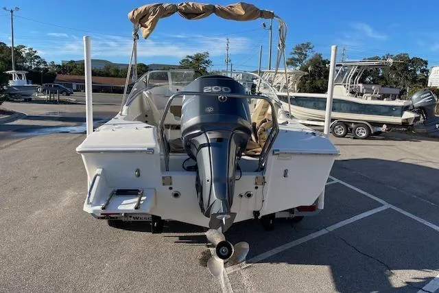 Slide: The Image of 2005 Scout 205 Dorado boat with outboard motor in a parking lot. - 3