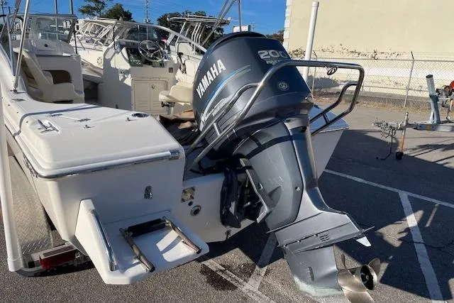 Slide: The Image of 2005 Scout 205 Dorado boat with Yamaha 200 outboard motor in a parking lot. - 4