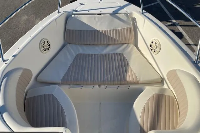 Slide: The Image of 2005 Scout 205 Dorado boat interior with beige cushioned seating. - 8