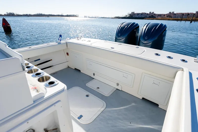 Slide: The Image of 2024 Steiger Craft 31 Fisherman boat interior with dual engines on a sunny day. - 10