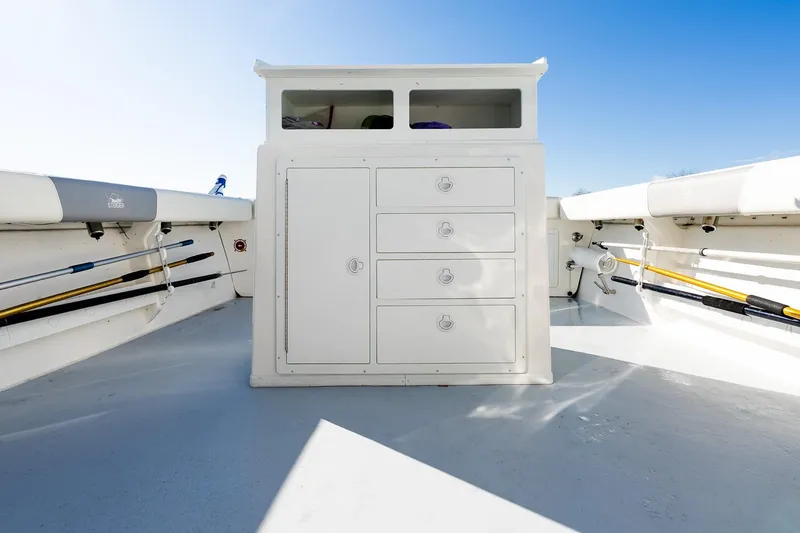 Slide: The Image of 2024 Steiger Craft 31 Fisherman boat interior with storage compartments and fishing rod holders. - 18