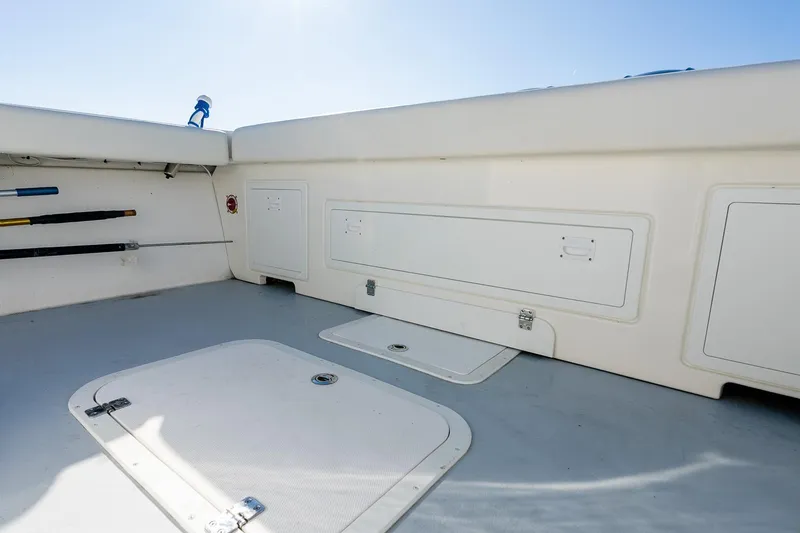 Slide: The Image of 2024 Steiger Craft 31 Fisherman boat interior with storage compartments and fishing rod holders. - 19