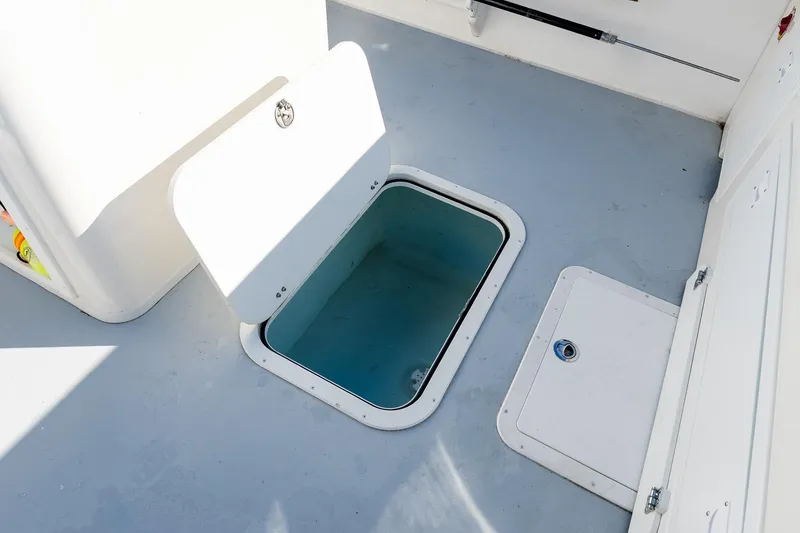 Slide: The Image of Open hatch on 2024 Steiger Craft 31 Fisherman boat deck, showcasing storage space. - 24