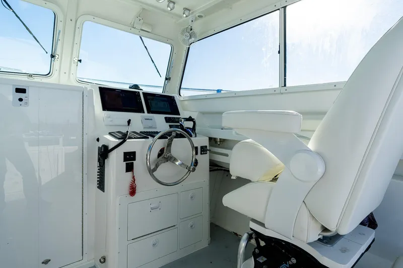 Slide: The Image of 2024 Steiger Craft 31 Fisherman helm with modern controls and comfortable captain's chair. - 30